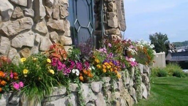 A stone building with a green awning and a window with a hexagonal pattern.