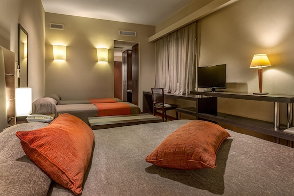 A hotel room with a bed, a desk, a television, and a chair. - Gran Hotel Argentino (Buenos Aires)