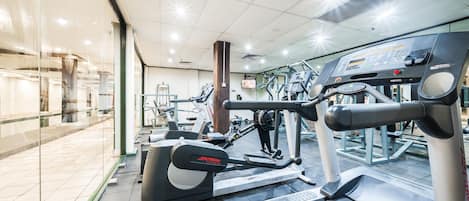A gym with various exercise equipment, including treadmills and weight machines.