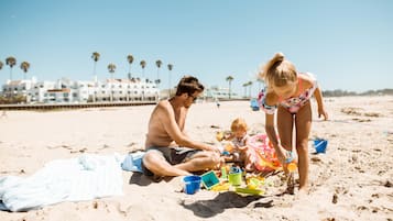 On the beach, white sand, sun loungers, beach towels