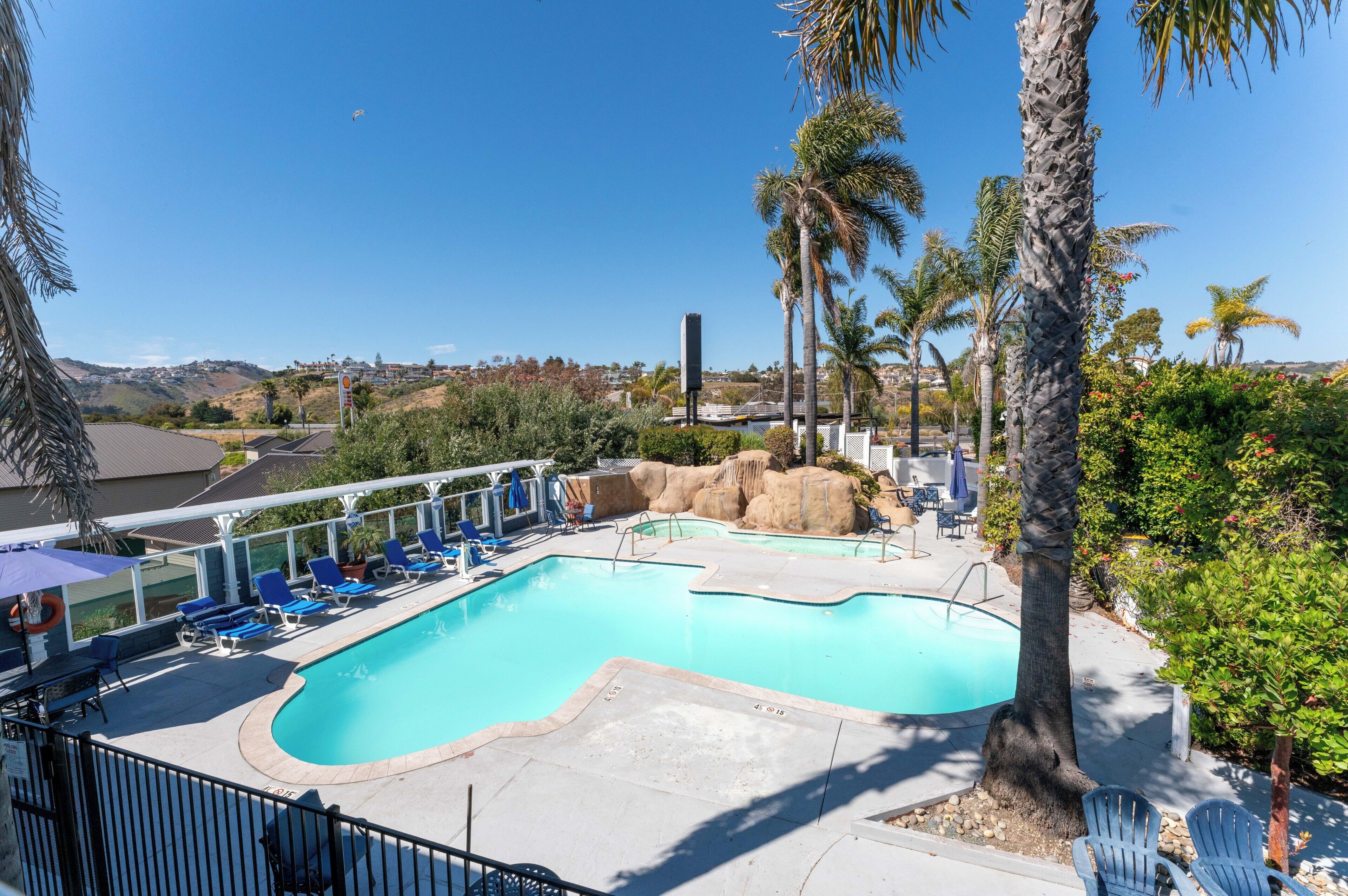 Outdoor pool, a heated pool, open 10:00 AM to 10:00 PM, pool umbrellas
