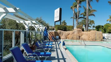 Outdoor pool, a heated pool, open 10:00 AM to 10:00 PM, pool umbrellas