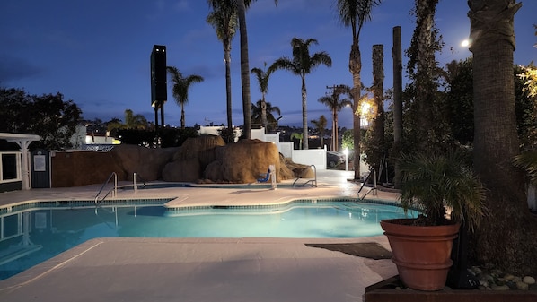 Outdoor pool, a heated pool, pool umbrellas, pool loungers