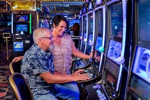 A casino environment with slot machines and an ATM.