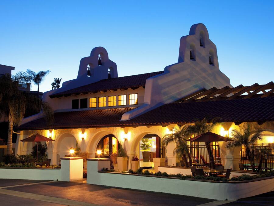 A building with a distinctive architectural style, featuring arched doorways and a bell tower.