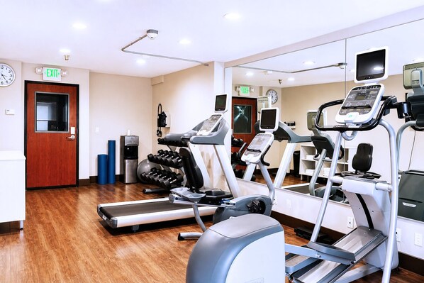 A gym with treadmills, elliptical machines, and free weights. - Holiday Inn Express San Clemente N – Beach Area by IHG (San Clemente)