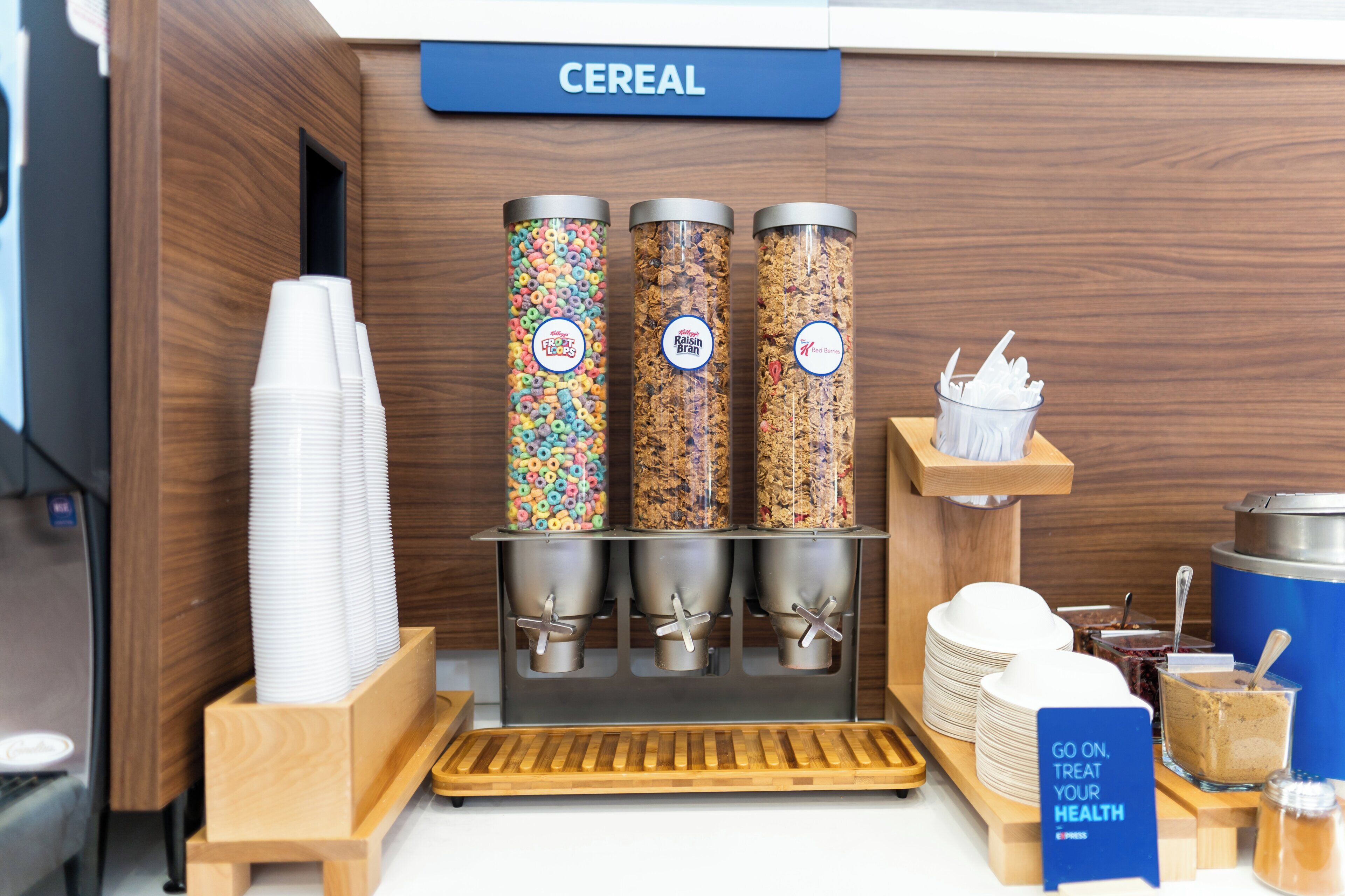 A cereal dispensing station with three containers labeled 'Froot Loops', 'Raisin Bran', and 'Red Berries'.