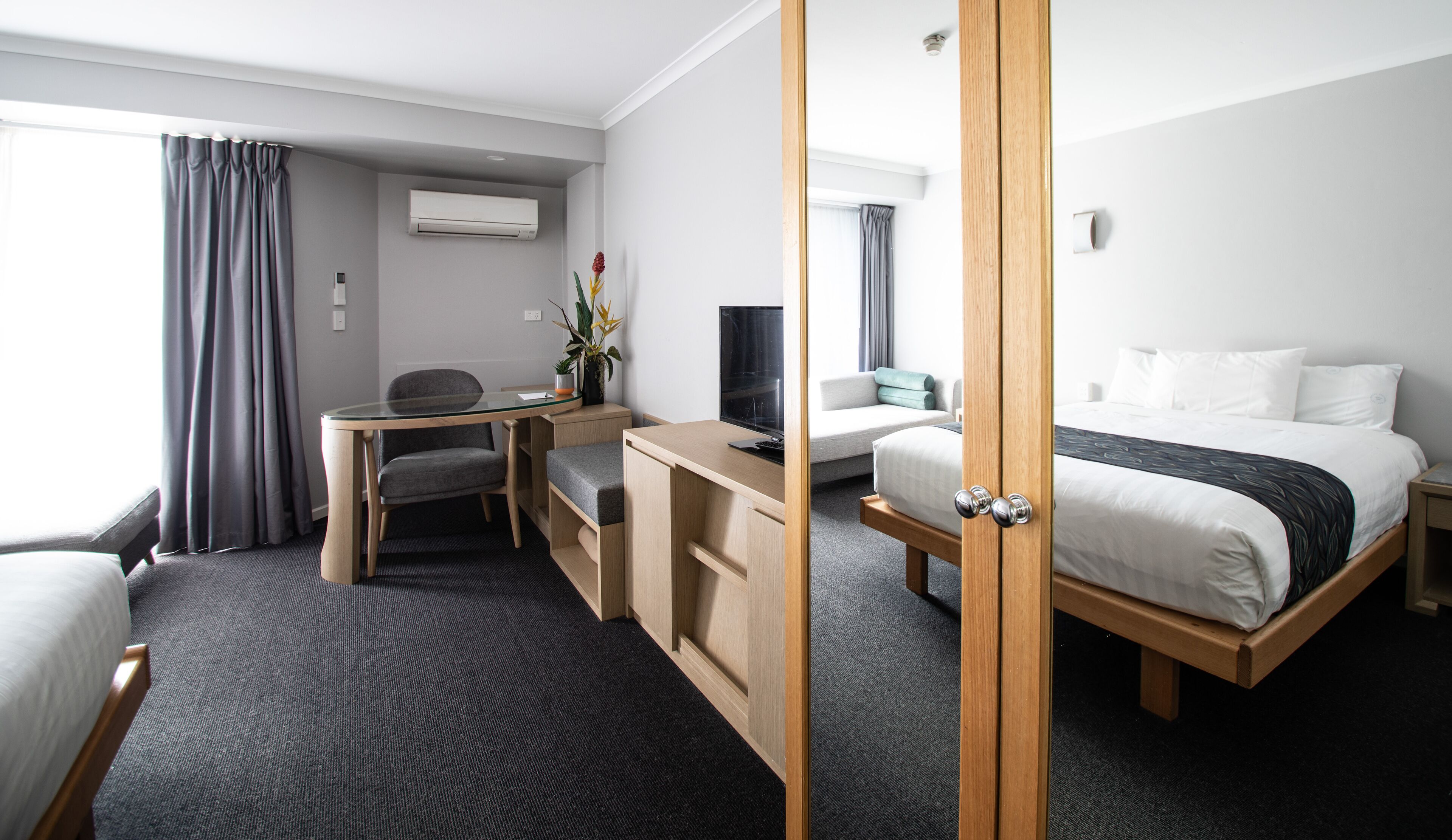 Premium bedding, laptop workspace, blackout curtains, soundproofing