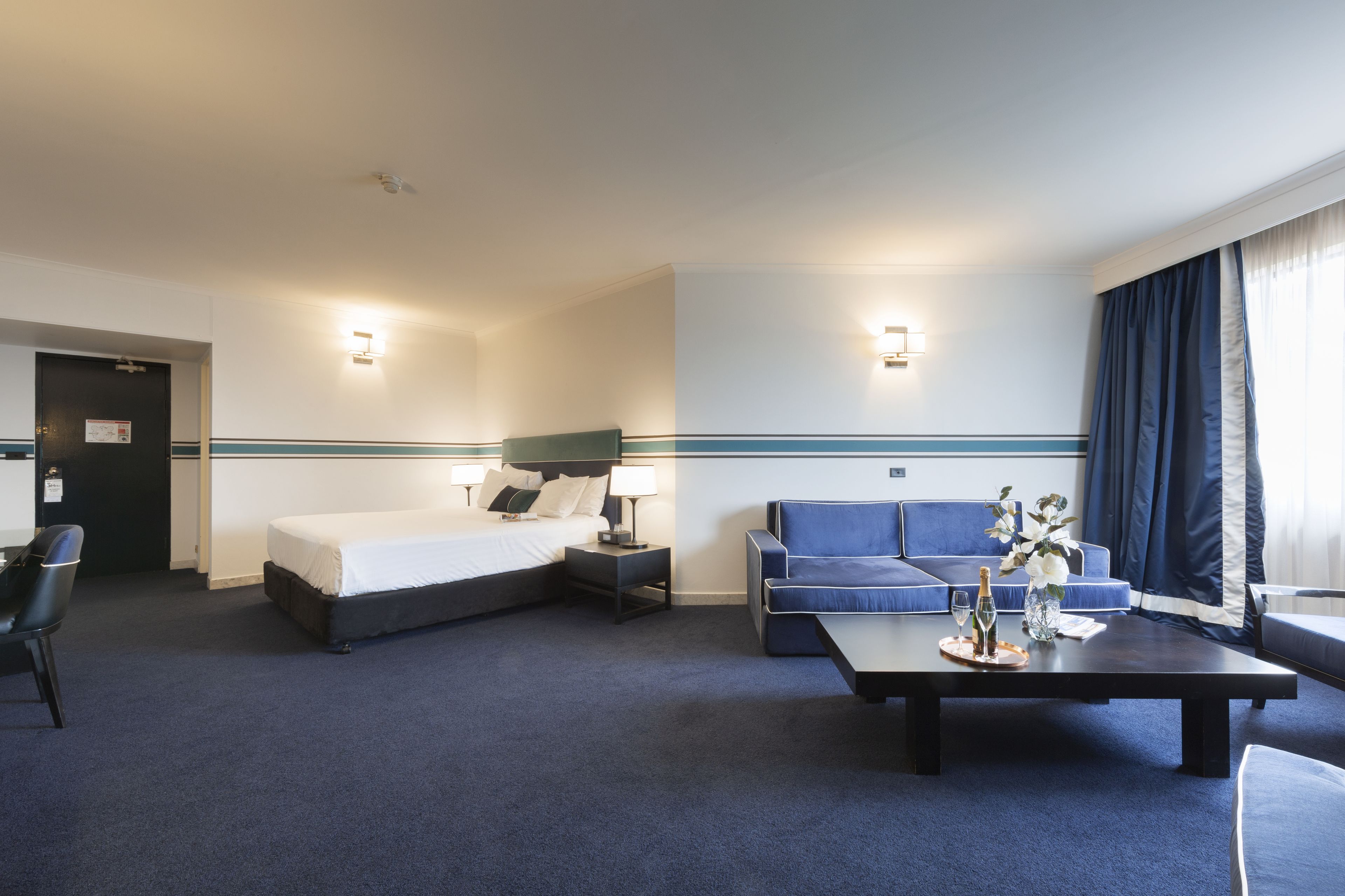 deluxe king room | living area | 40-cm flat-screen tv with satellite channels, tv, books