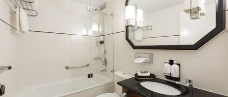 A modern bathroom with a bathtub, toilet, and sink.
