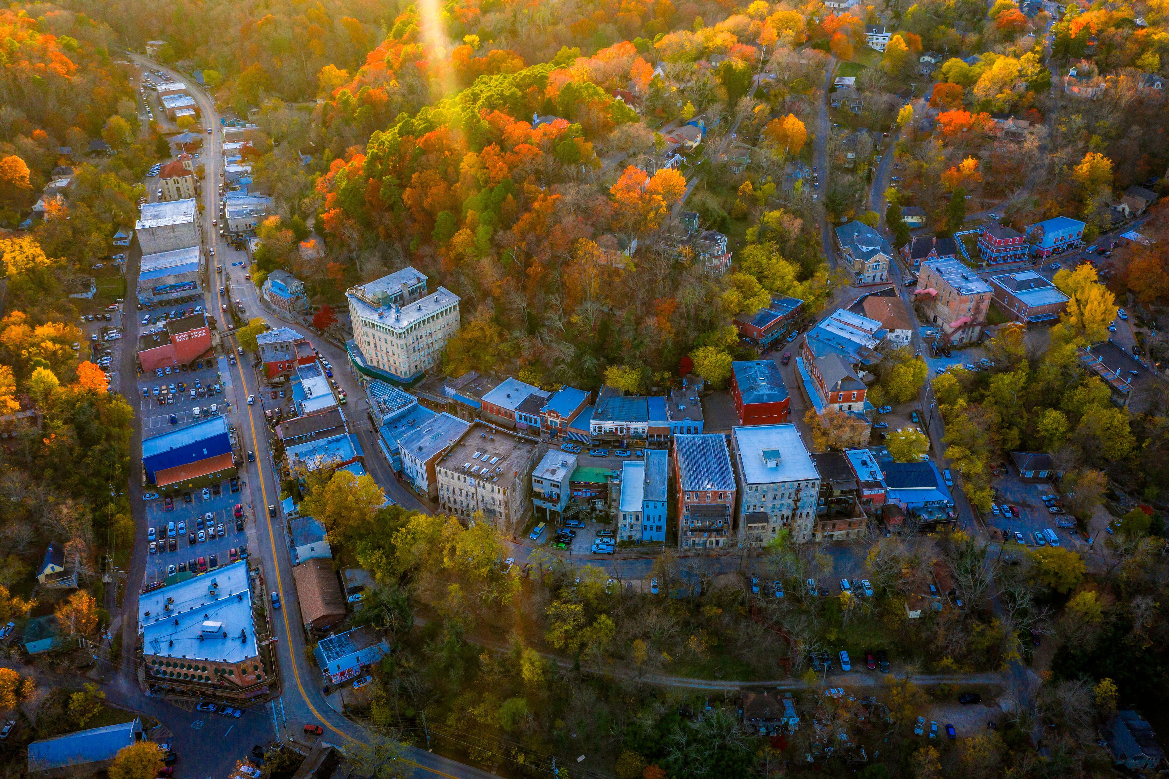 An aerial view of a town with buildings, roads, and trees.