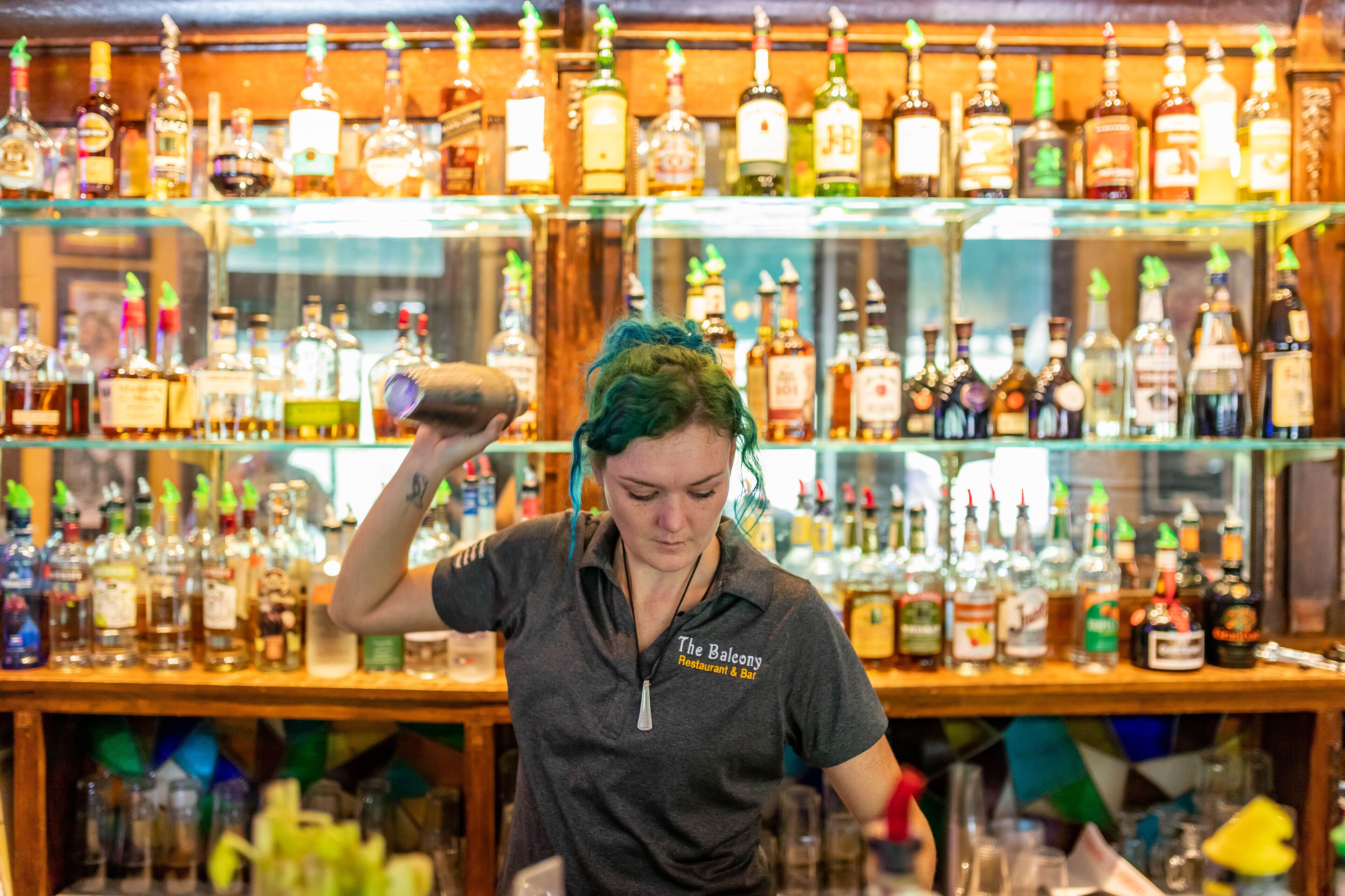 A bar with shelves of various liquor bottles.