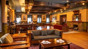 A bar area with a pool table, a sofa, and a fireplace. - Basin Park Hotel and Spa (Eureka Springs)