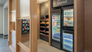 A corner market with refrigerated display cases and shelves stocked with snacks and beverages. - Fairfield Inn & Suites by Marriott Scottsdale Old Town (Scottsdale)