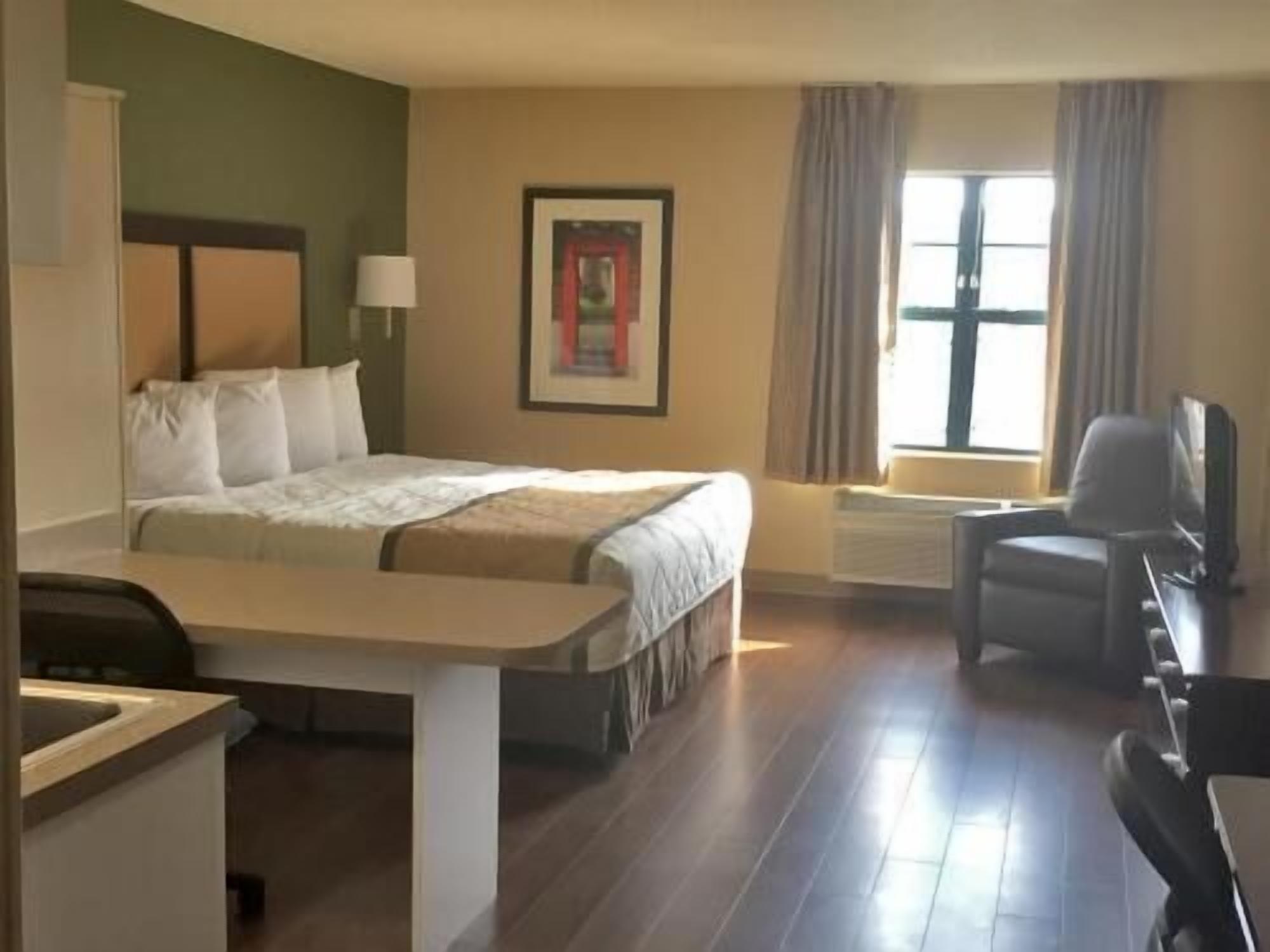 Desk, laptop workspace, blackout drapes, iron/ironing board