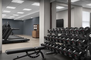 A gym with treadmills, dumbbells, and a weight bench. - Hampton Inn Indianapolis Downtown Across from Circle Centre (Indianapolis)
