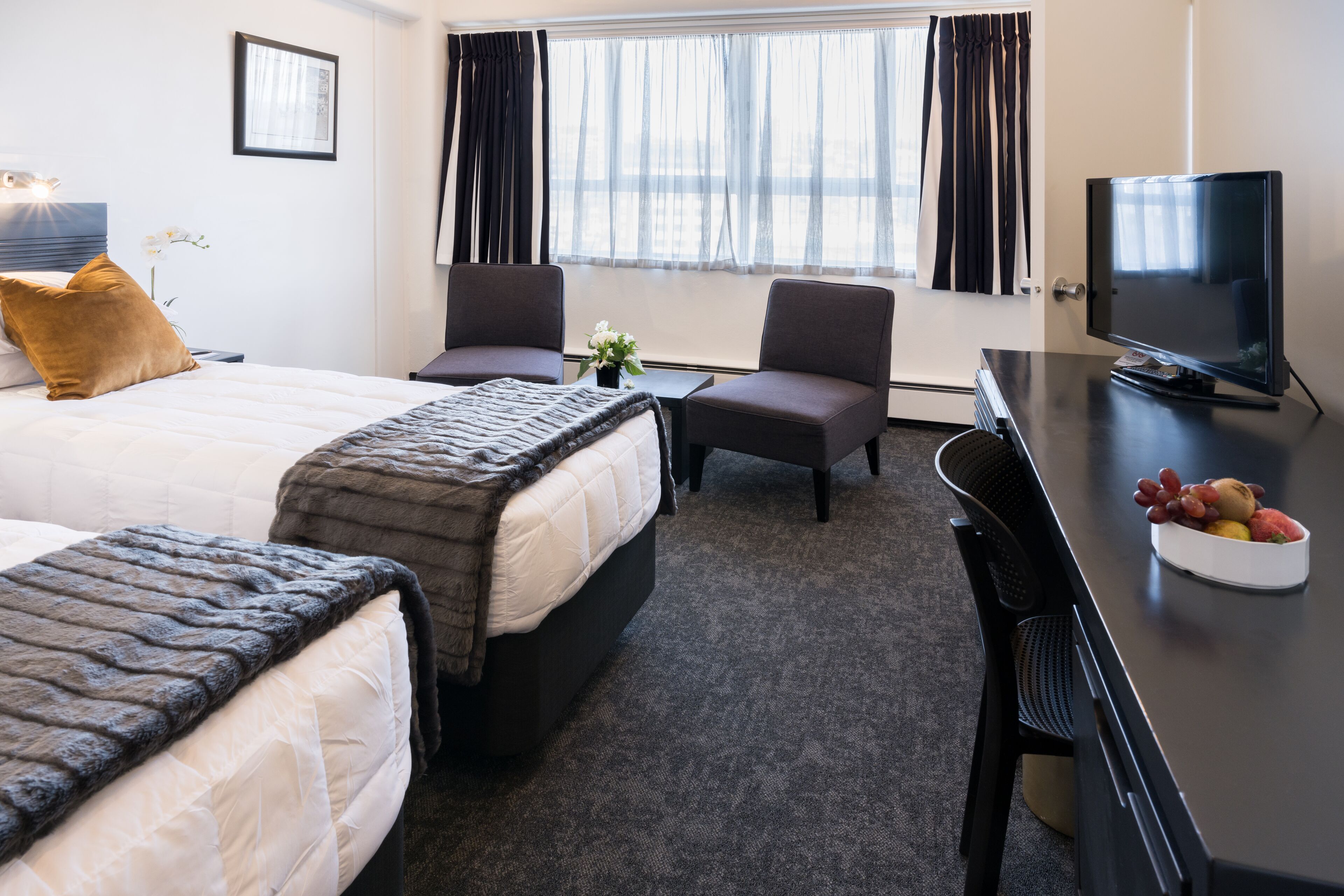 standard twin room | in-room safe, desk, laptop workspace, iron/ironing board