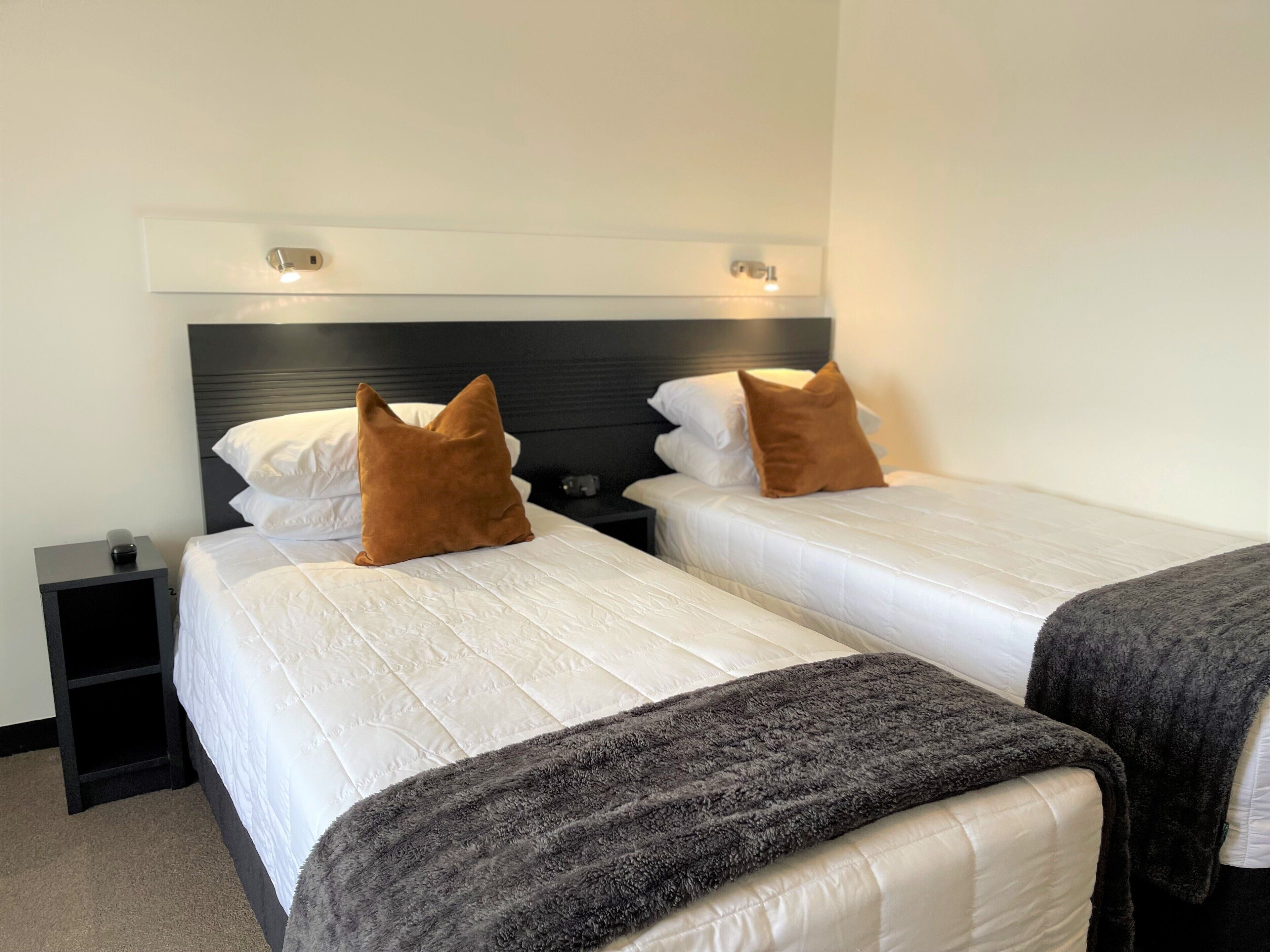 standard twin room | in-room safe, desk, laptop workspace, iron/ironing board