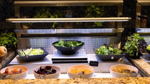 A buffet with various food options including salads, vegetables, and legumes. - SkyCity Hotel (Auckland)