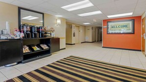 A reception area with a welcome sign, a coffee station, and a buffet counter. - Extended Stay America Suites Syracuse Dewitt (East Syracuse)