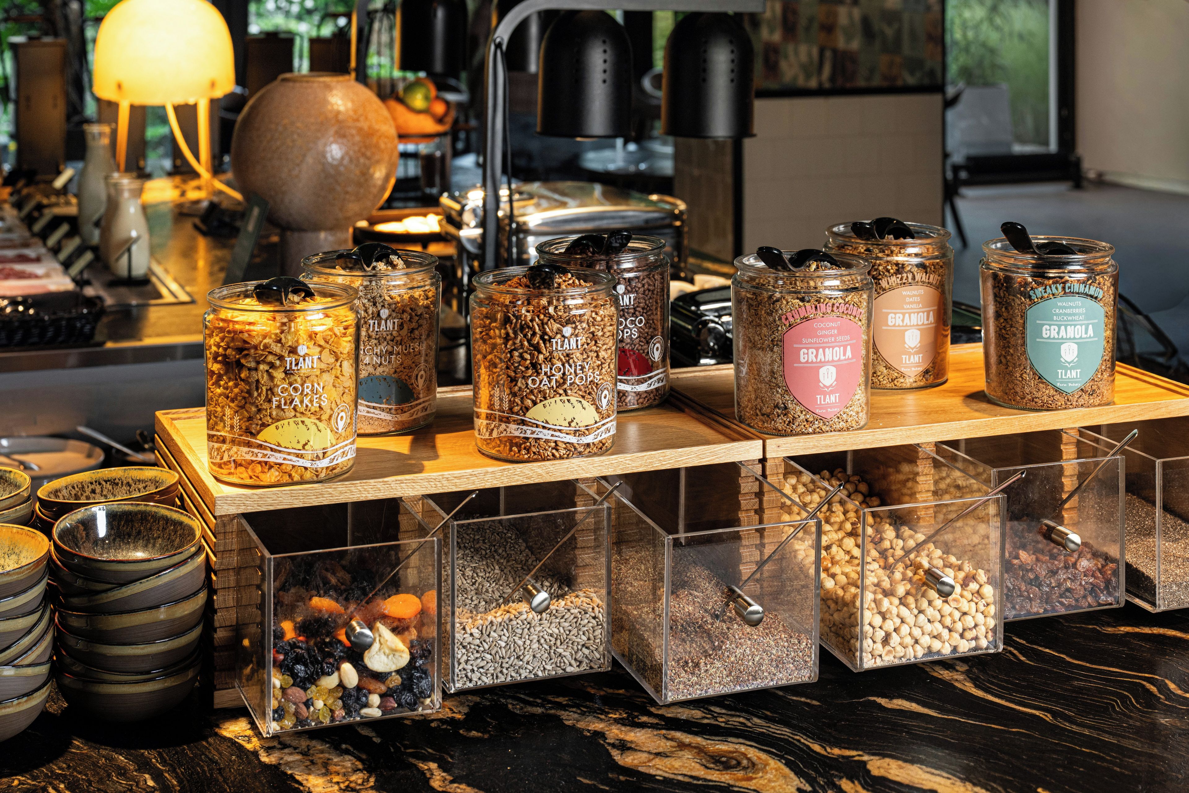 A variety of food items in jars and containers on a wooden counter.