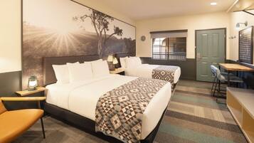 A hotel room with a large bed, a desk, a chair, and a view of the outdoors.