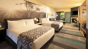 A hotel room with two beds, a desk, a chair, a TV, and a large window. - Mountain Modern Sedona, Tapestry Collection by Hilton (Sedona)