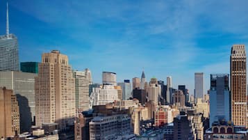 A cityscape with a variety of high-rise buildings, including a prominent skyscraper with a spire.