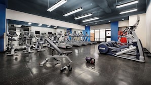 A modern gym with various exercise equipment, including treadmills, weight machines, and free weights. - NEW YORKER BY LOTTE HOTELS (New York)