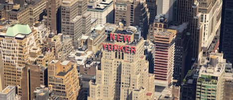 A high-rise building with "NEW YORKER" prominently displayed on its facade.