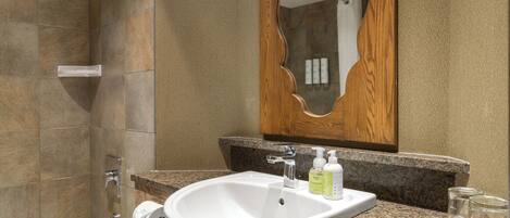 A bathroom with a bathtub, a sink, and a mirror.