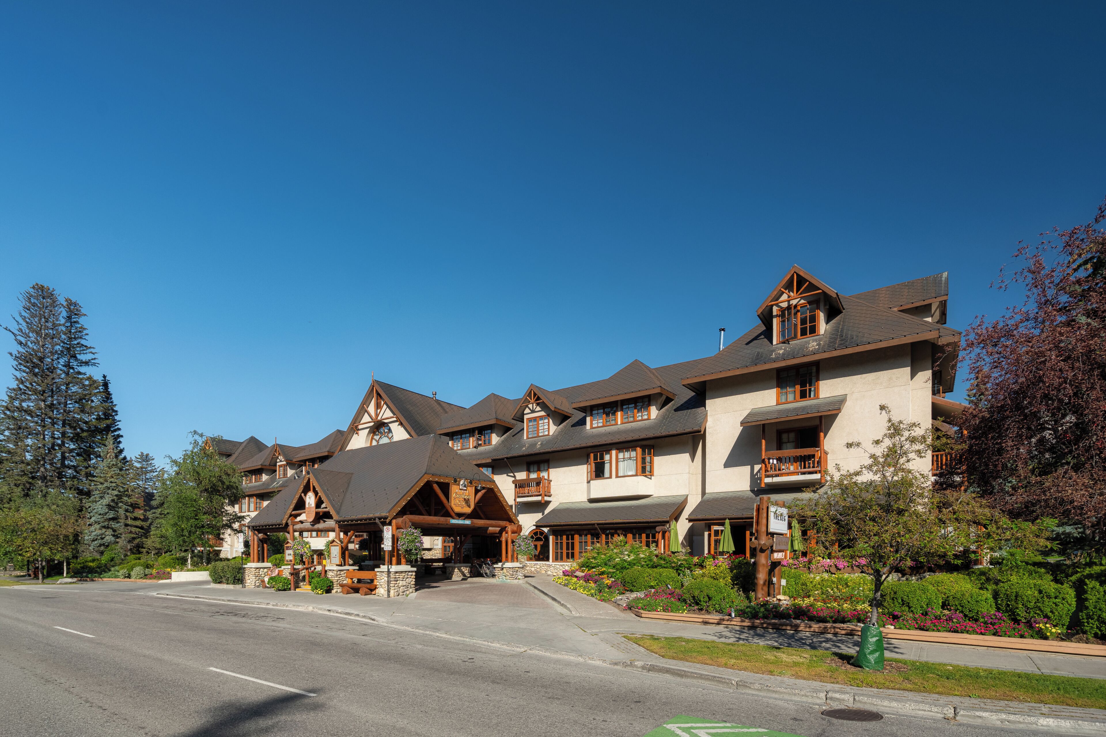 A multi-story hotel with a traditional architectural style, featuring a central entrance with a covered porch and multiple balconies.