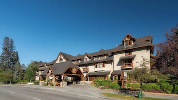 A multi-story hotel with a traditional architectural style, featuring a central entrance with a covered porch and multiple balconies.