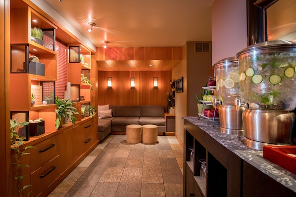 A modern kitchen with wooden cabinets, a built-in oven, and a large island with a sink. - Banff Caribou Lodge and Spa (Banff)
