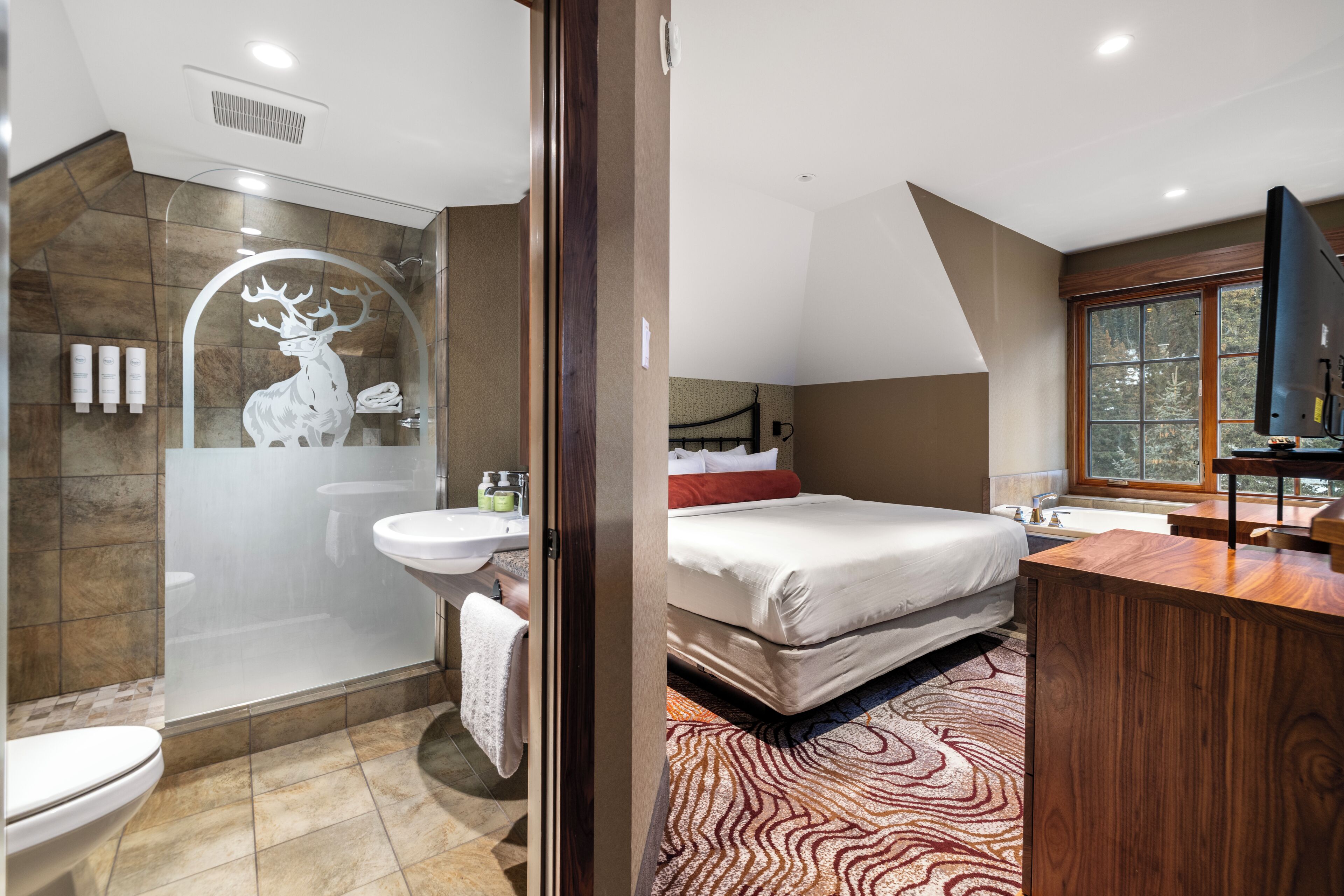 A modern bathroom with a glass shower enclosure, a white sink, and a large mirror.