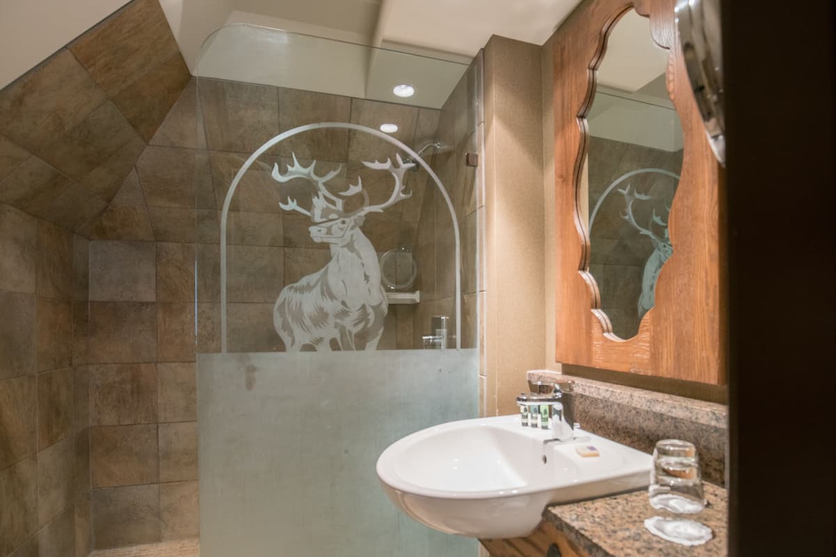 corner suite with spa bath | bathroom | eco-friendly toiletries, hair dryer, towels