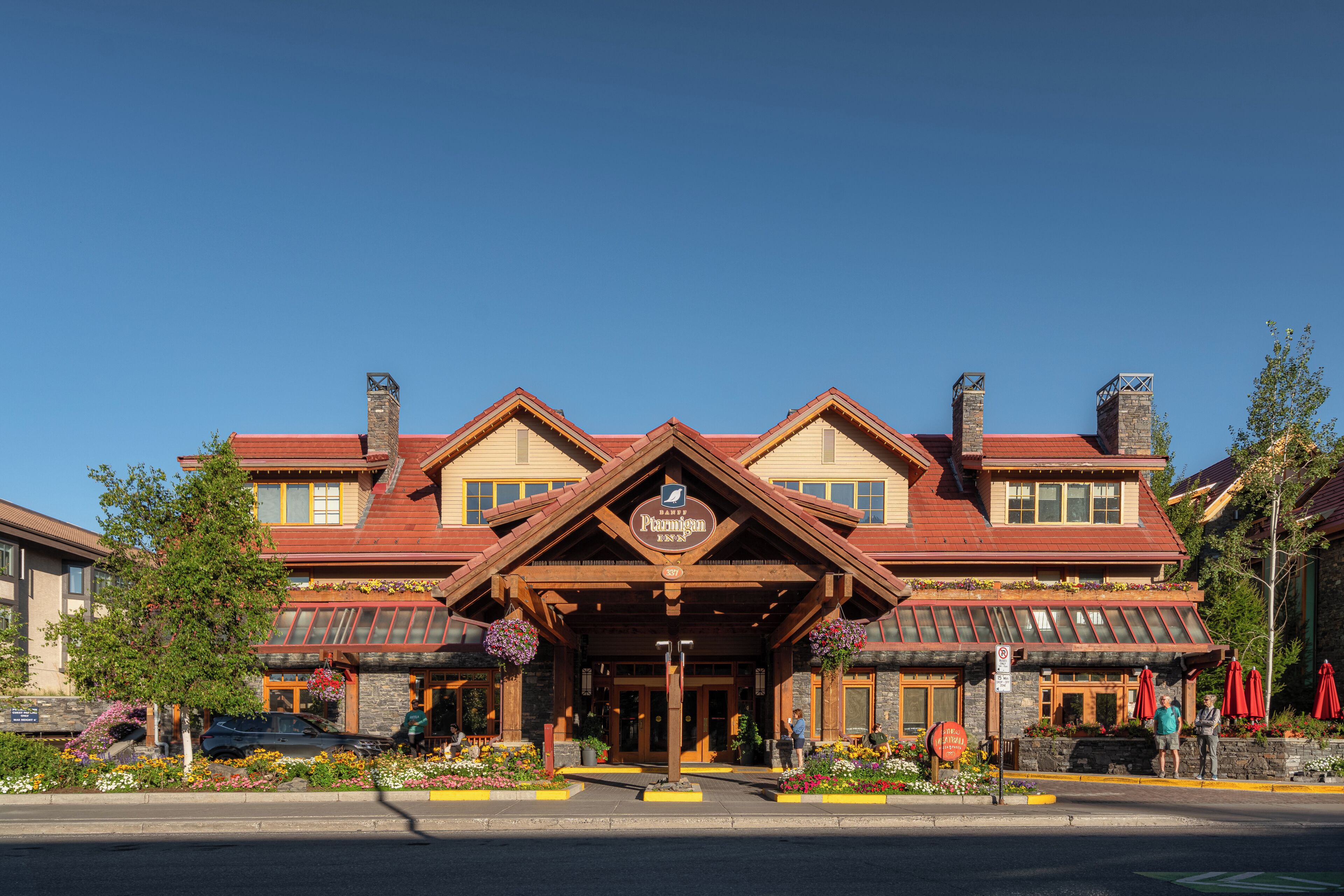 A building with a prominent entrance, a sign indicating it is a B&B, and a stone facade.