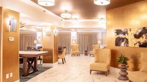 A hotel lobby with a marble floor, a reception desk, and seating areas. - Hampton Inn & Suites Jackson-Coliseum (Jackson)