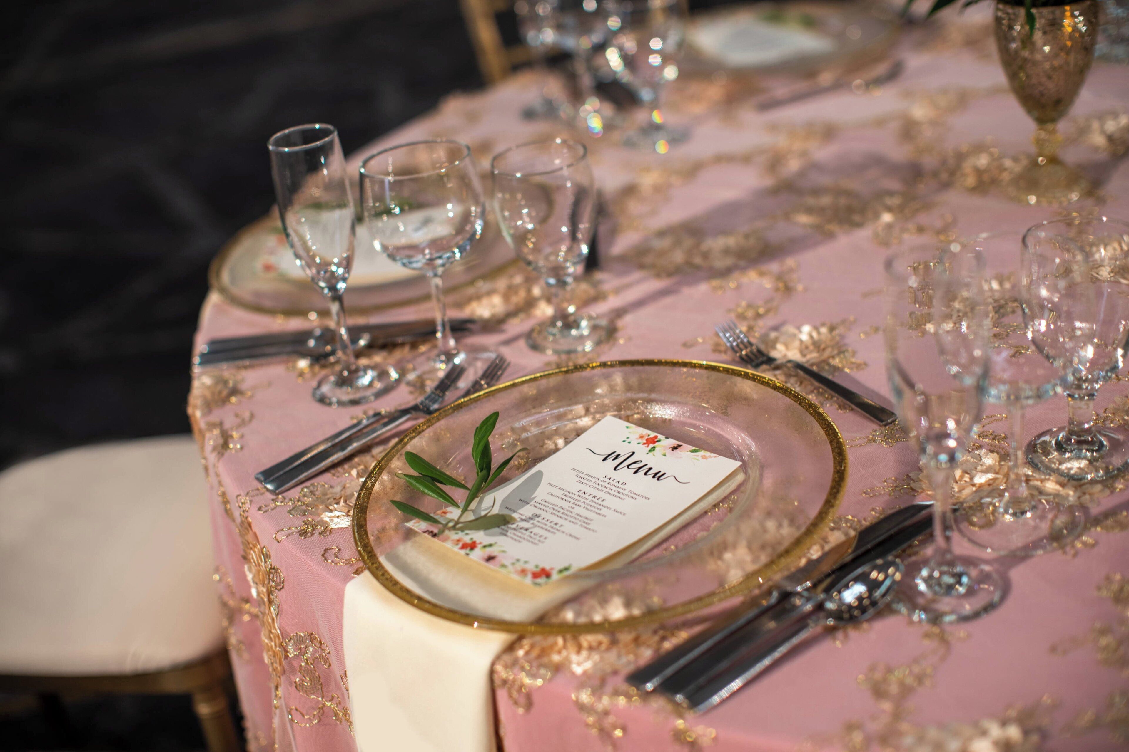 A table set for a formal dining occasion with a menu card.