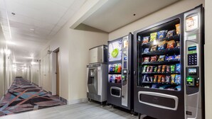 A hotel corridor with vending machines and a small ice cream freezer. - Quality Inn & Suites Omaha Chalco (Omaha)