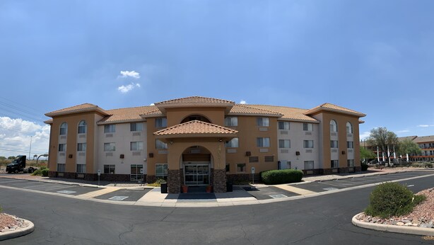 A multi-story hotel with a central entrance, parking lot, and surrounding landscaping. - Comfort Inn & Suites near Kino Sports Complex (Tucson)