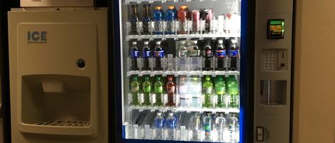 A vending machine stocked with various beverages including Pepsi, water, and sports drinks.