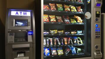 An ATM machine with a vending machine next to it.