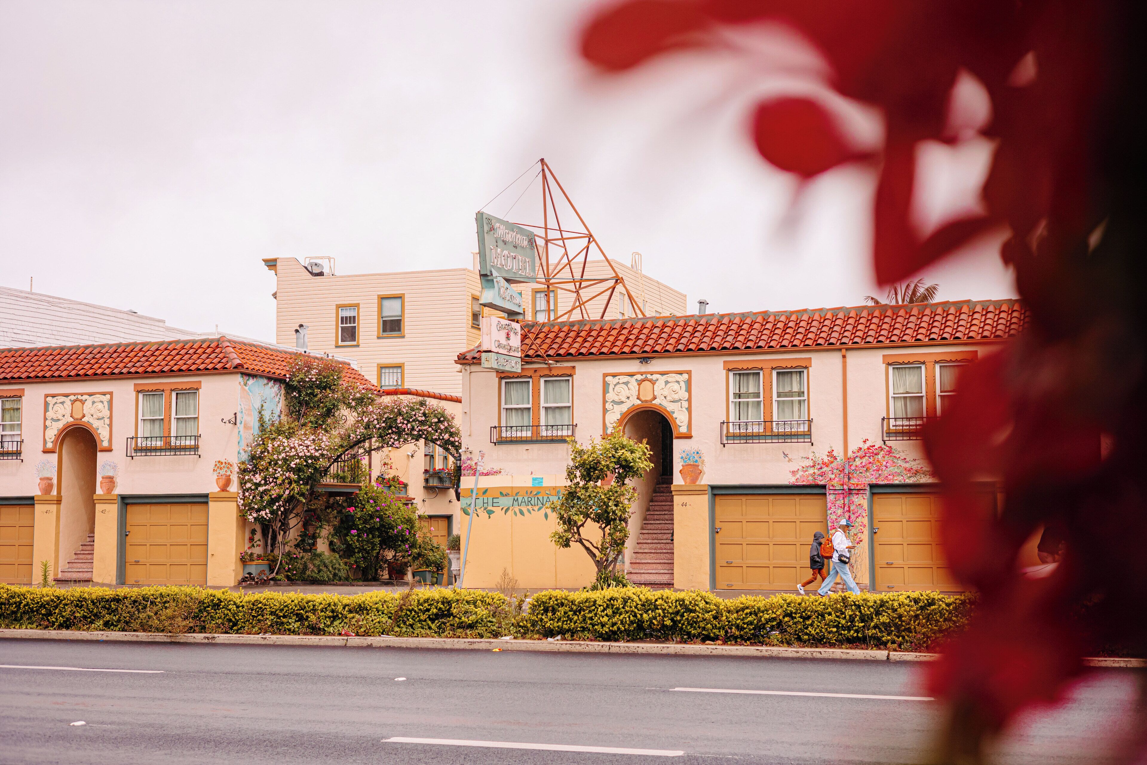 A building with a red-tiled roof, a sign reading "The Marina," and a staircase leading to an entrance.