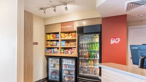 A snack bar with a variety of packaged foods and beverages, a Lenovo computer station, and a FACP sign. - TownePlace Suites by Marriott Greensboro Coliseum Area (Greensboro)