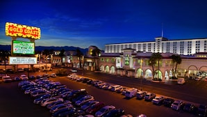 A large hotel with a casino, multiple parking lots, and a prominent sign advertising a $2A Heineken promotion. - Gold Coast Hotel and Casino (Las Vegas)