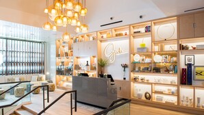 A modern interior with a reception desk, wooden flooring, and a staircase. - The Vanderpump Las Vegas Hotel Casino - A Caesars Rewards Destination (Las Vegas)