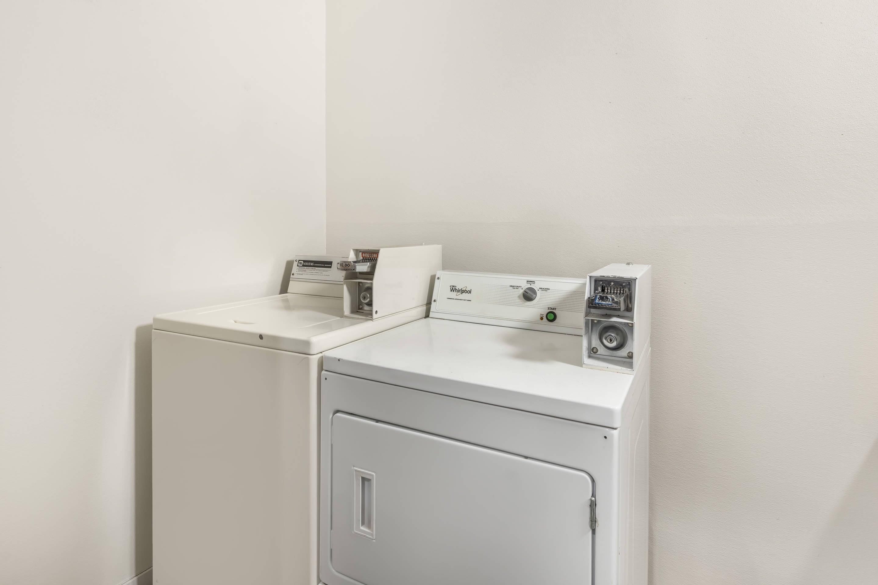 A compact, white, front-loading washer and dryer unit with a control panel on top.