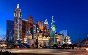 A cityscape with prominent buildings including a tall skyscraper and a statue. - New York-New York Hotel & Casino (Las Vegas)