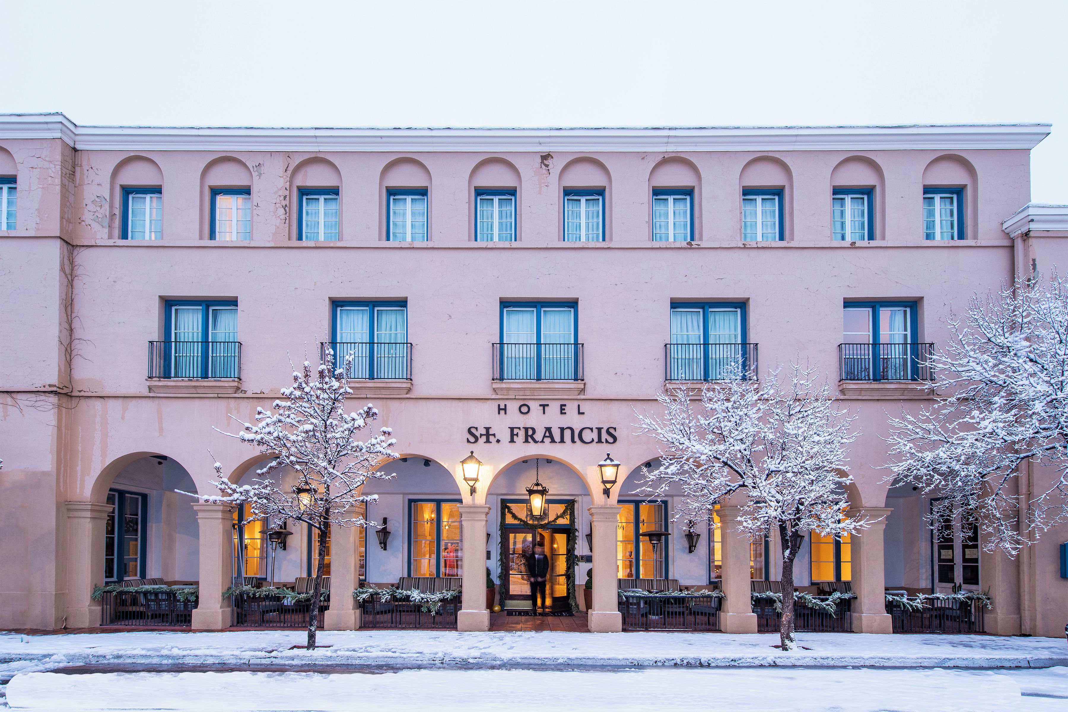 A pink building with the sign 'HOTEL ST. FRANCIS' and multiple windows.